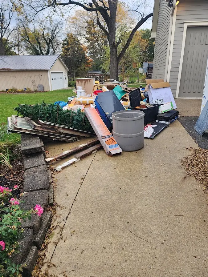 Dumpster being loaded with debris for 12 Yard Dumpster Rental in Crittenden